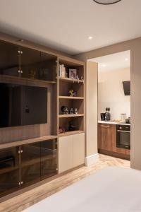 a living room with a large flat screen tv at Charles of Mayfair in London