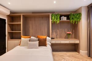 a bedroom with a bed with plants on the wall at Charles of Mayfair in London