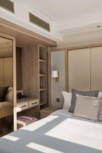 a bedroom with a large white bed and a mirror at Charles of Mayfair in London