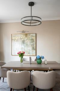 a dining room table with chairs and a painting at Charles of Mayfair in London