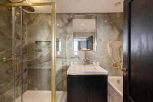 a bathroom with a shower and a sink at Charles of Mayfair in London