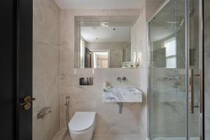 a bathroom with a shower and a toilet and a sink at Charles of Mayfair in London