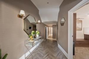 a hallway of a house with a mirror on the wall at Charles of Mayfair in London