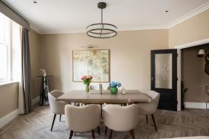 a dining room with a wooden table and chairs at Charles of Mayfair in London