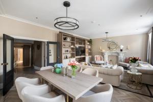 a living room with a table and chairs at Charles of Mayfair in London