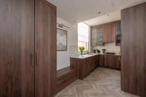 a kitchen with wooden cabinets and a counter at Charles of Mayfair in London