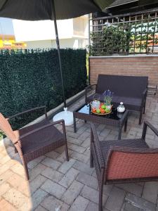a patio with two chairs and a table with an umbrella at Casa di Elena in Mottella
