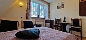 Posteľ alebo postele v izbe v ubytovaní Pokoje Apartamenty Pod Limbą