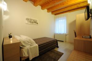 Posteľ alebo postele v izbe v ubytovaní Albergo Leon Bianco Gonars