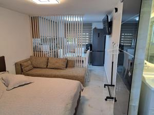 a living room with a bed and a couch at Good Holiday in Kallithea Halkidikis