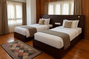Postel nebo postele na pokoji v ubytování Norbu Healing Hotel