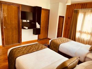 Postel nebo postele na pokoji v ubytování Norbu Healing Hotel