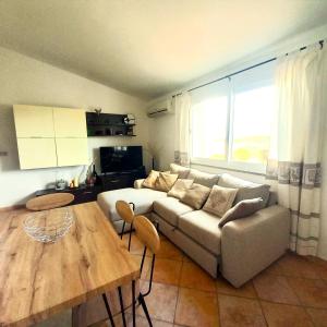 a living room with a couch and a table at DreamHouse Miramare in Budoni