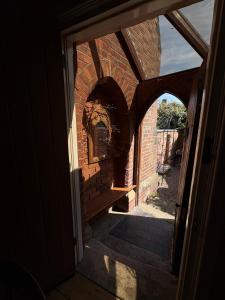 an entrance to a brick building with an open door at Cosy Cottage in Melbourne in Melbourne
