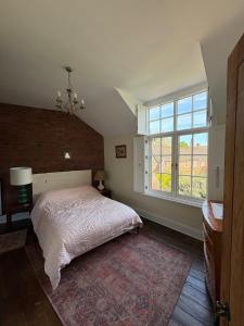 a bedroom with a bed and a large window at Cosy Cottage in Melbourne in Melbourne