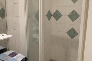 a shower with a glass door in a bathroom at Le Grand Sénat - 55m2 in Chambéry