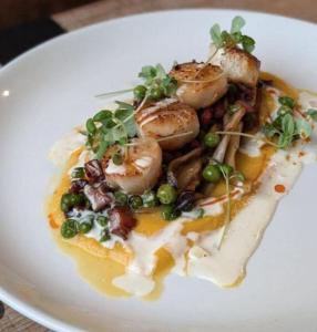 a white plate of food with scallops and vegetables at Sunset in Saint-Jean-de-Monts +11 photos