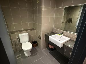un baño con inodoro y lavabo en Cosy Residence Homestay 2, en Kota Kinabalu 4 fotos más