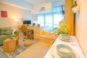 a living room with a couch and a table at Free Parking Promo! Eastwood LeGrand 3 - Mowai Suites in Manila