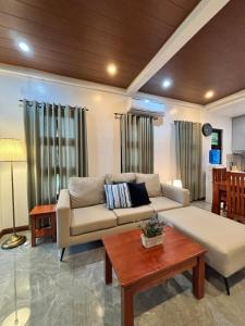 a living room with a couch and a table at JCPM Apartment Suite-3rd Floor in Santa Cruz