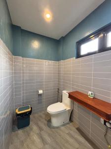 a bathroom with a white toilet and a window at JCPM Apartment Suite-3rd Floor in Santa Cruz +8 photos