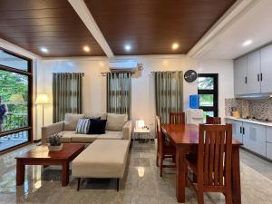 a kitchen and living room with a table and a couch at JCPM Apartment Suite-3rd Floor in Santa Cruz