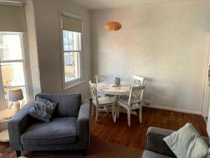 a living room with a table and chairs and a couch at St James Dairy in Ilfracombe