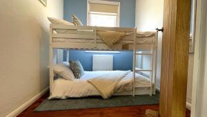 a bedroom with two bunk beds in a room at St James Dairy in Ilfracombe