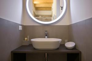 a bathroom with a white sink and a mirror at La Còrt Apartments - Number 2 in Manerba del Garda