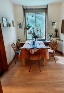 a dining room with a wooden table and chairs at Goldner Stern Kaub in Kaub