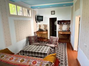 a living room with a couch and a table at Hayq Guest House in Goris