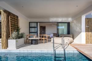 a house with a swimming pool and a living room at Abalone Hotel & Villas in Paternoster