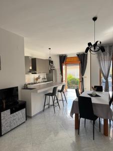 a kitchen and dining room with a table and chairs at G&N apartment in Agropoli