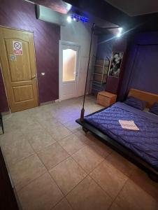 a bedroom with a bed in a room with a door at Cazare RĂSFĂȚ in Focşani +6 photos