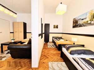 a living room with two beds and a couch at Kert Panzió in Sárospatak