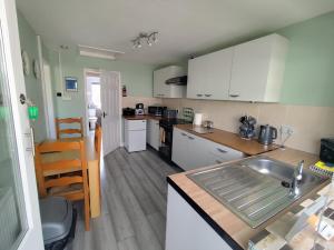 a kitchen with a sink and a counter top at Y Nyth in Newtown