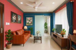 a living room with red and blue walls and a couch at La Serena - Phu My Hung in Ho Chi Minh City