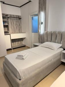 a bedroom with a large bed in a room at Villa Shehu in Ksamil