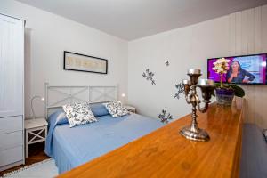 a bedroom with a bed with a wooden table at Apartments Severina in Rovinj