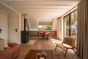 a living room with a couch and a table at Boshuisje Rekem - Ember in Lanaken