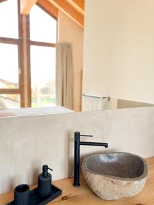 a bathroom with a stone sink on a counter at Pleta Moragas in Osséja +34 photos