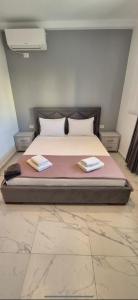 a bedroom with a bed with two towels on it at The Darling Guesthouse in Himare +18 photos