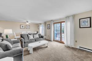 a living room with a couch and a table at Santanoni 60H - Renovated Townhome with Privacy in North Creek +22 photos