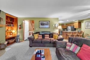 a living room with a couch and a table at Otter Slide 78I - A Cozy Mountain Retreat in North Creek