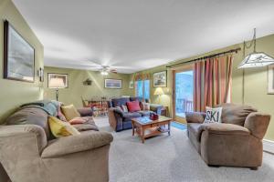 a living room with two couches and a table at Otter Slide 78I - A Cozy Mountain Retreat in North Creek +16 photos