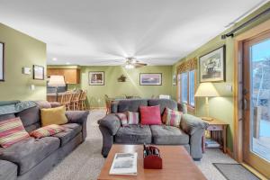 a living room with two couches and a table at Otter Slide 78I - A Cozy Mountain Retreat in North Creek