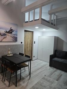 a living room with a black table and a couch at Apartament Patio Antresol 2 Świnoujście in Świnoujście