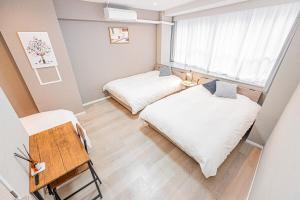 Postel nebo postele na pokoji v ubytování jinbocho str walk 6 min ,4 floors building 4dk for 13 person, 新宿駅12分 秋葉原5分 東京駅7分 銀座駅7分 渋谷20分