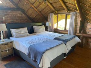 Ένα ή περισσότερα κρεβάτια σε δωμάτιο στο Crocriver Chalet Schoemanskloof