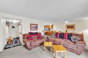 a living room with two couches and a table at Pine Knot 62H - Retreat with Private Play Area in North Creek